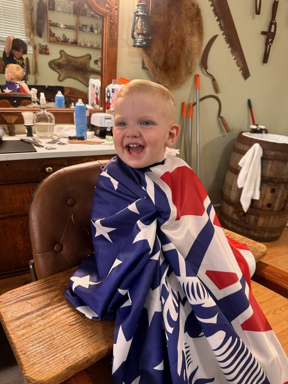 Tony’s young son smiling in the same patriotic cape